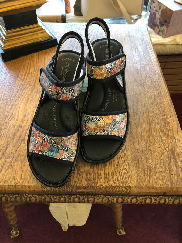 Ilene Sandal | Sandal available in:  Denim blue and black basket weave pattern   Black and white check print accented by antique colored flowers  Adjustable velcro strap at ankle  Back strap  Anti-shock inner sole  Available in sizes 36-41. Size chart conversion is shown below.