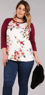 Becky Floral Top | Floral print  Burgundy, pink, blue, yellow, orange, and green on a white background   3/4 sleeve  Raglan sleeve  Machine washable   Available 1X - 3X